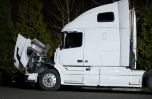 Semi truck with open hood and engine repairs