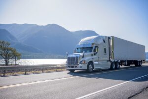 Big rig semi truck with chrome accessories transporting frozen c